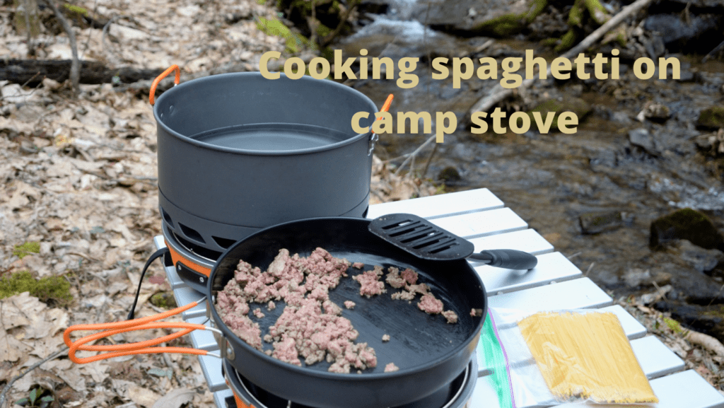 Cooking spaghetti on camp stove 