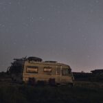 a mobile home under a starry night sky