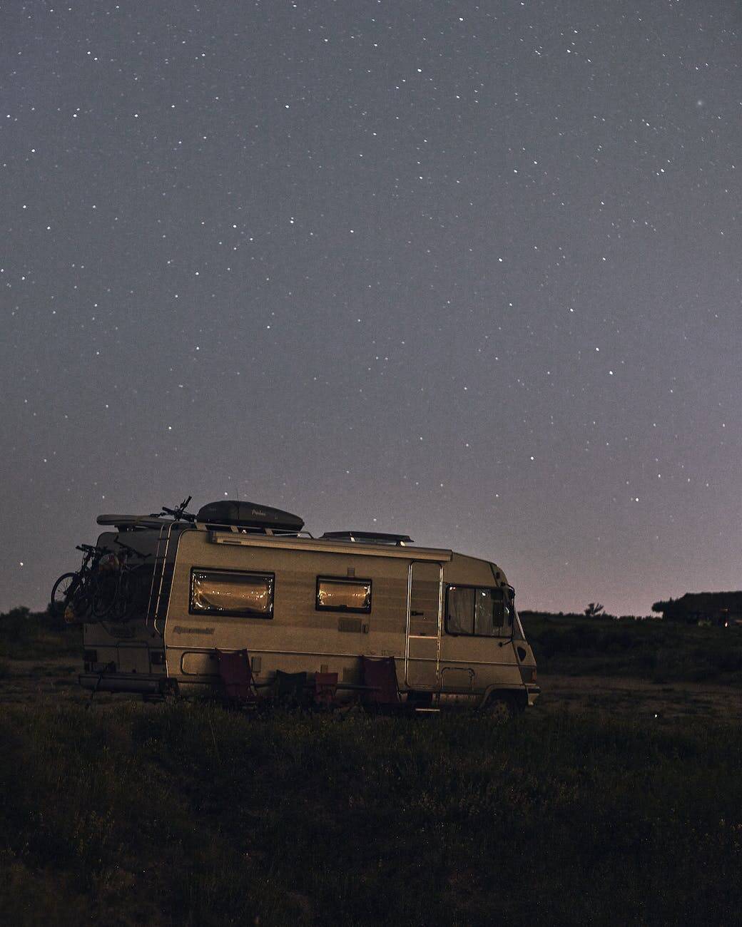 a mobile home under a starry night sky