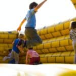 children playing on inflatable castle