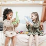 photo of two girls playing with stuffed animals