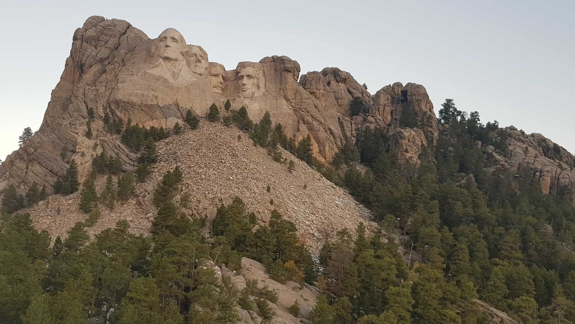 gigantic faces carved on rough mountain slope