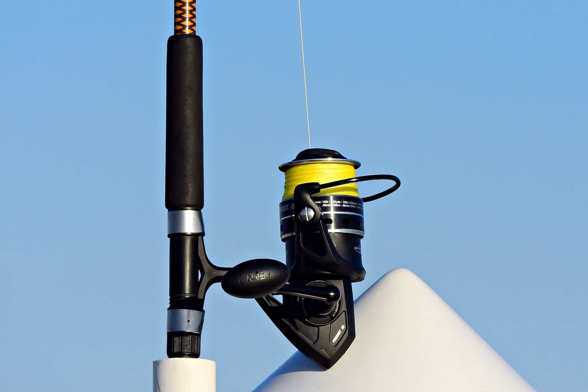 fishing rod with line placed in boat