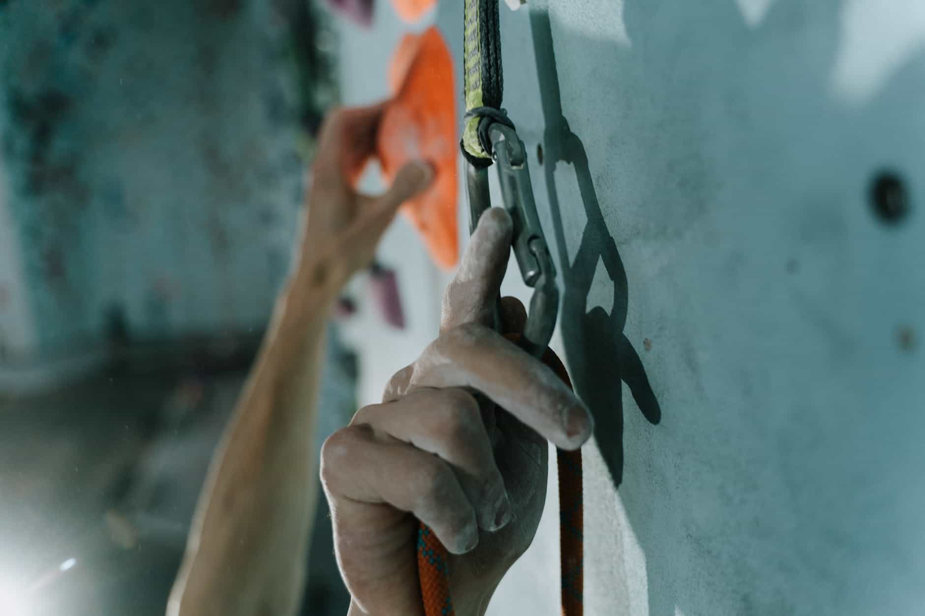 close up photo of a person holding a carabiner