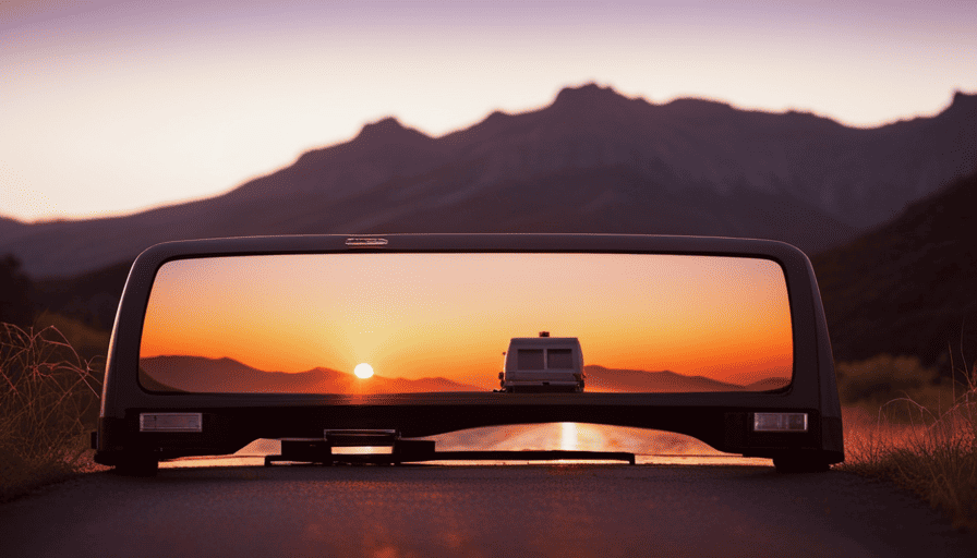 An image showcasing a striking sunset backdrop, casting a warm, golden hue over a sturdy truck camper