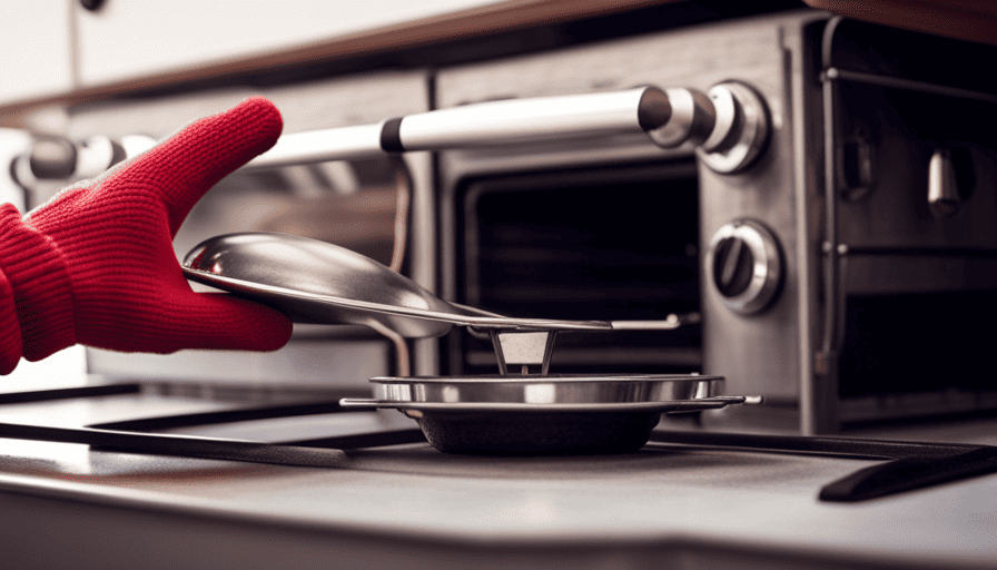 An image showcasing a pair of hands wearing oven mitts, delicately turning the temperature dial on a sleek Greystone camper oven, while the soft glow of the oven's interior illuminates the surrounding kitchenette